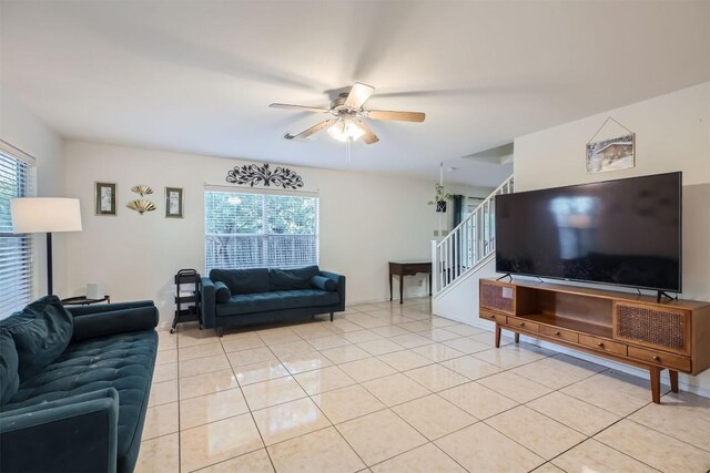 living room featuring light tile patterned floors, plenty of natural light, and ceiling fan