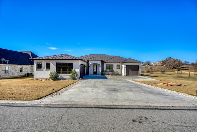 view of front of house featuring central air condition unit, a front lawn, and a garage