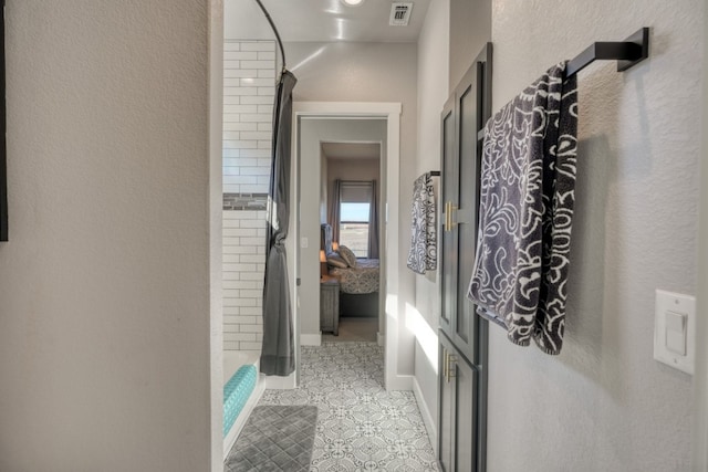 hall with light tile patterned floors