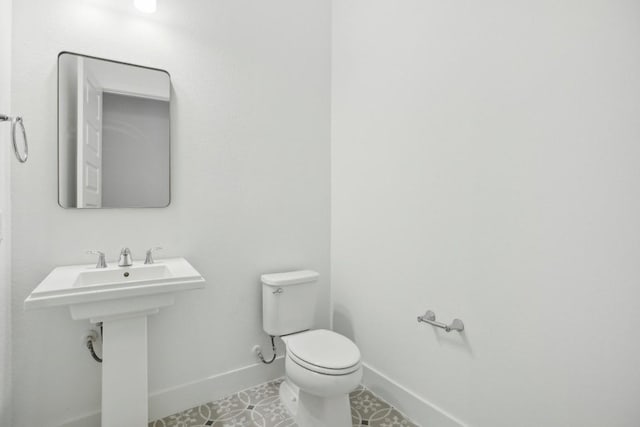 bathroom with tile patterned floors, sink, and toilet