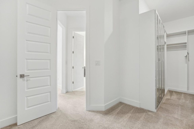 hallway with light colored carpet