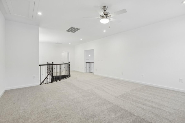 unfurnished room with ceiling fan and light colored carpet