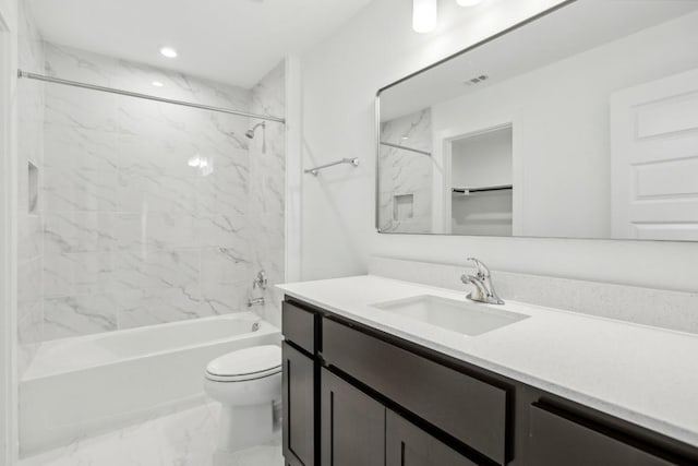 full bathroom with toilet, vanity, and tiled shower / bath