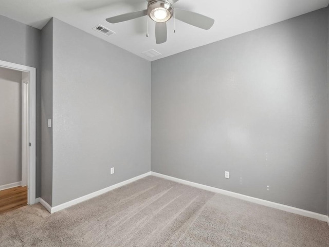 carpeted spare room with ceiling fan