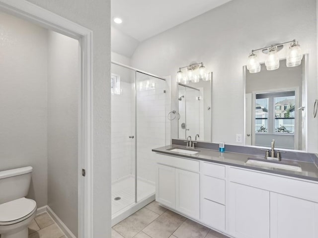 bathroom featuring tile patterned flooring, vanity, toilet, and a shower with shower door