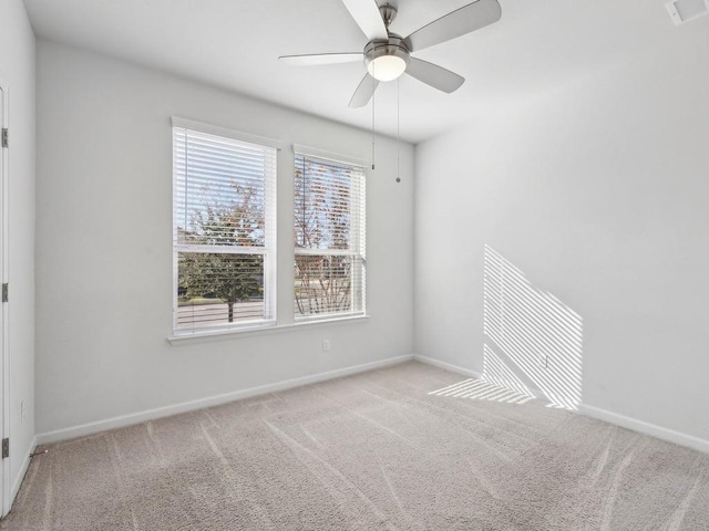 carpeted empty room featuring ceiling fan