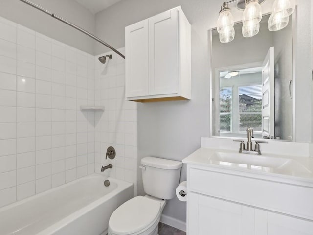 full bathroom featuring vanity, tiled shower / bath combo, and toilet