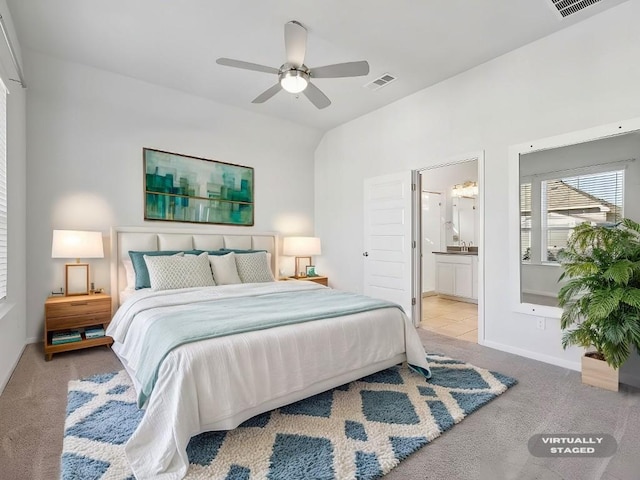 carpeted bedroom featuring ensuite bathroom and ceiling fan