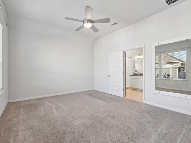 spare room featuring ceiling fan and light colored carpet