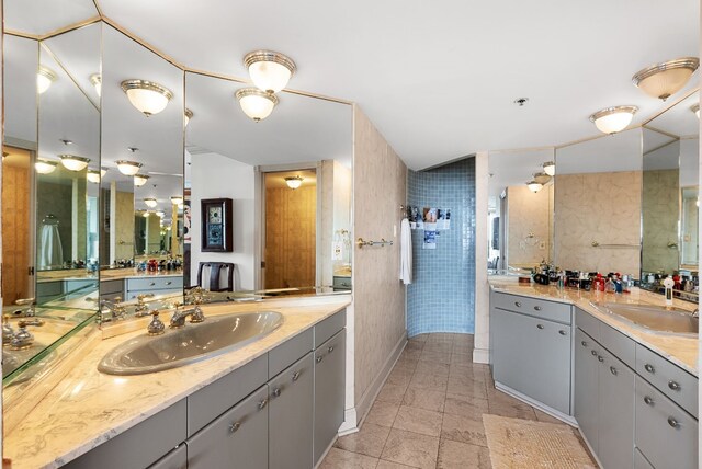 bathroom featuring vanity and tile walls