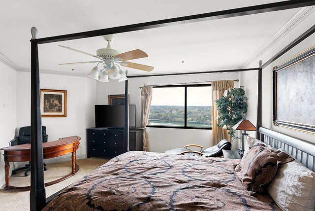 carpeted bedroom with ceiling fan and ornamental molding