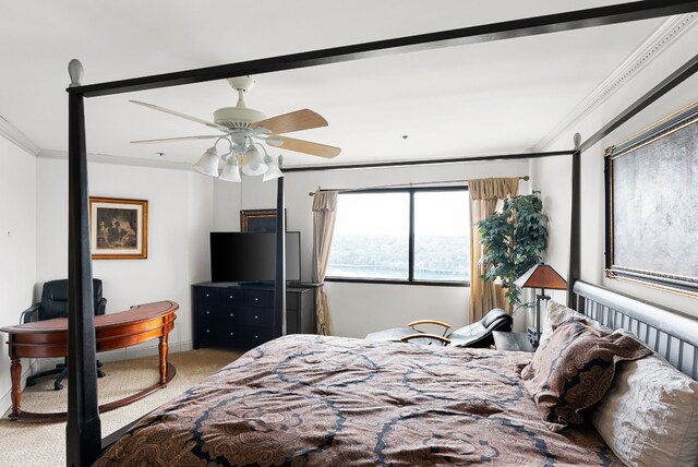 carpeted bedroom featuring ceiling fan and crown molding