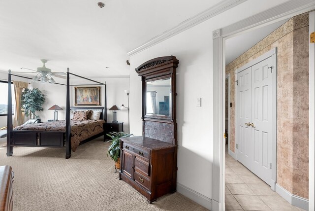 tiled bedroom featuring ceiling fan and crown molding