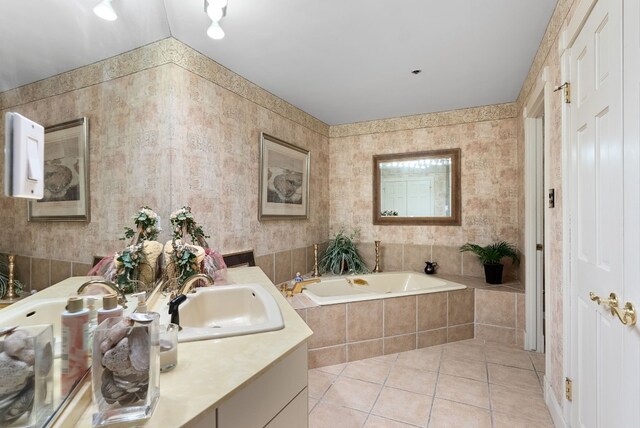 bathroom featuring vanity, tile patterned floors, and tiled tub