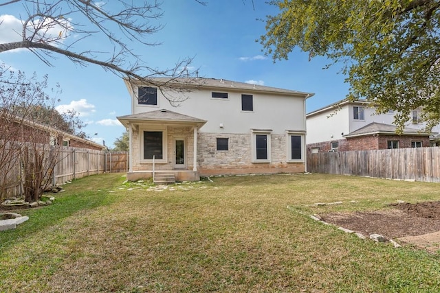 rear view of property with a yard