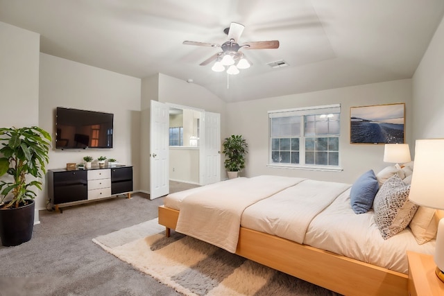 carpeted bedroom featuring vaulted ceiling and ceiling fan