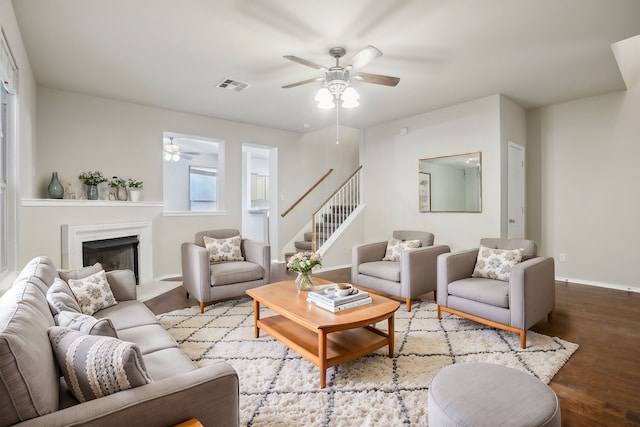 living room featuring wood-type flooring and ceiling fan