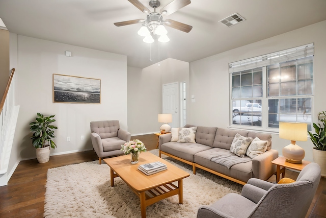 living room featuring dark wood-type flooring and ceiling fan