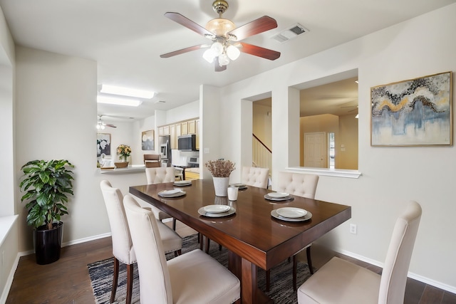 dining room featuring dark wood-type flooring and ceiling fan