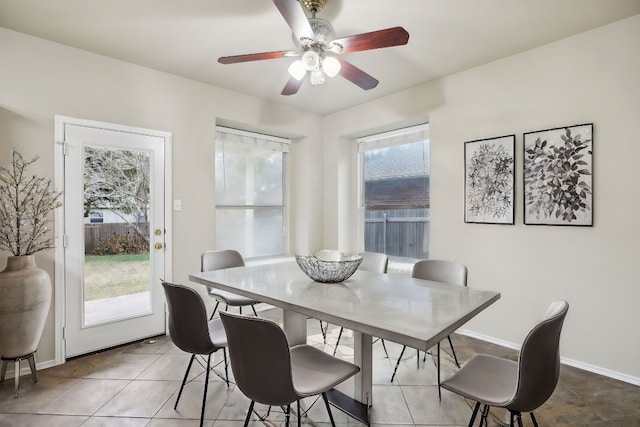 dining space with a healthy amount of sunlight, light tile patterned floors, and ceiling fan