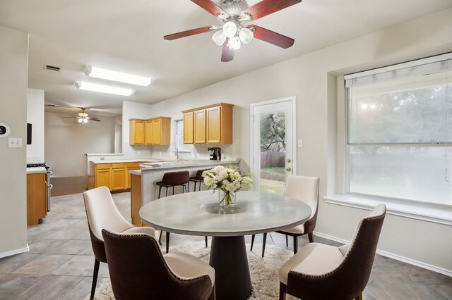 dining area with sink and ceiling fan