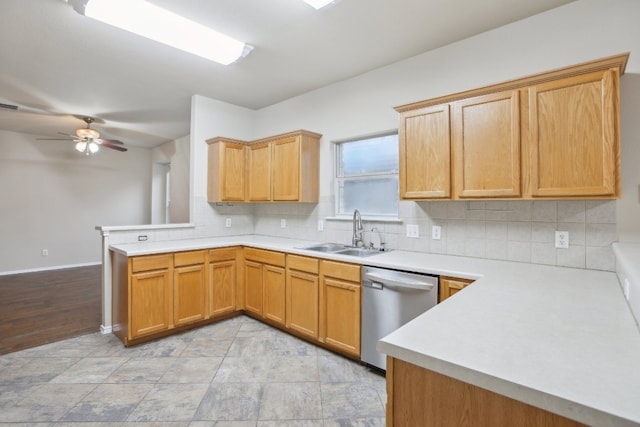 kitchen featuring tasteful backsplash, sink, kitchen peninsula, and dishwasher