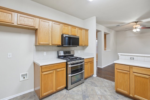 kitchen featuring tasteful backsplash, appliances with stainless steel finishes, and ceiling fan