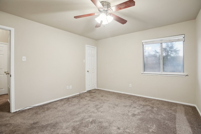 spare room featuring carpet floors and ceiling fan