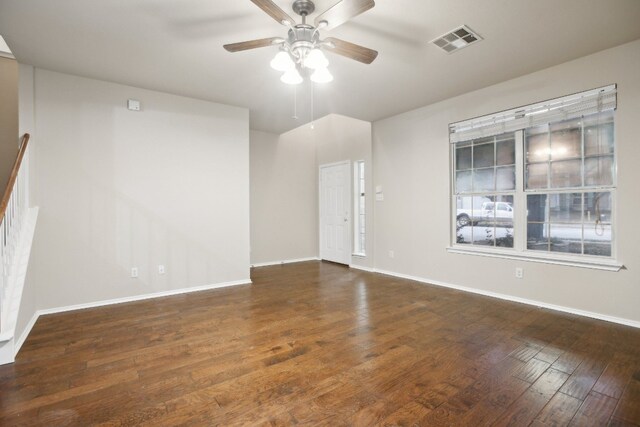 empty room with ceiling fan and dark hardwood / wood-style flooring