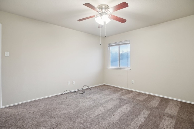 spare room with ceiling fan and carpet