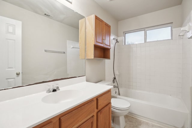 full bathroom featuring vanity, toilet, and tiled shower / bath