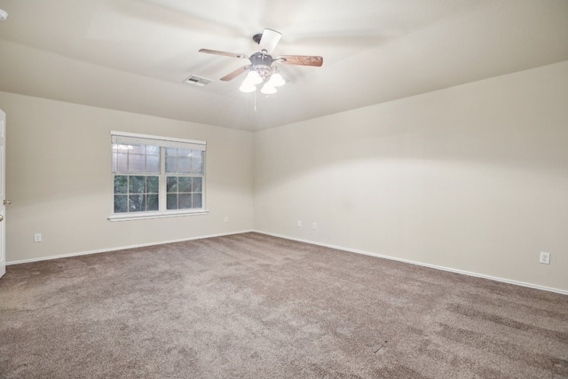 carpeted spare room featuring ceiling fan