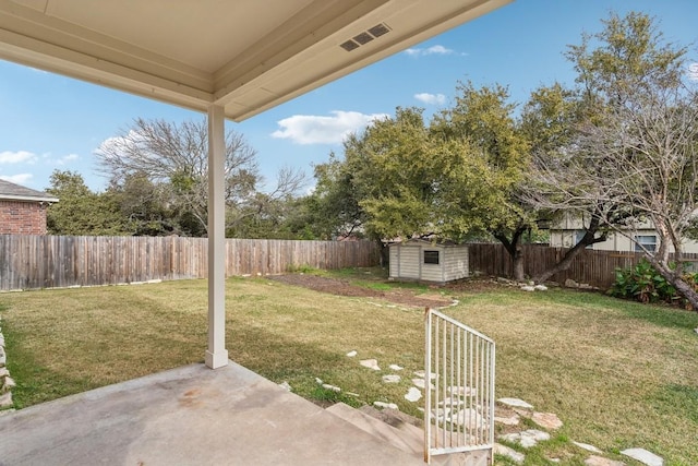 view of yard with a storage shed and a patio area