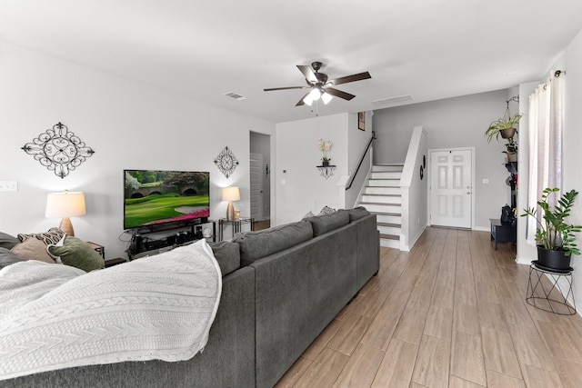 living room featuring wood-type flooring and ceiling fan