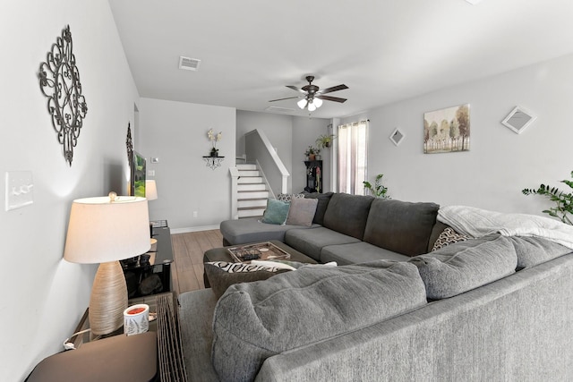 living room with hardwood / wood-style floors and ceiling fan