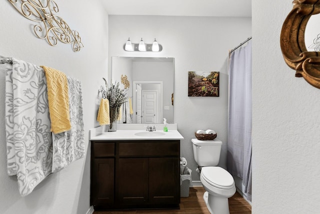 bathroom with vanity, wood-type flooring, and toilet