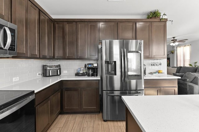 232 Syrah Ct, Leander, TX 78641 - kitchen featuring appliances with stainless steel finishes, light countertops, backsplash, and ceiling fan