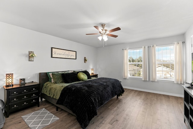 bedroom with ceiling fan and hardwood / wood-style flooring