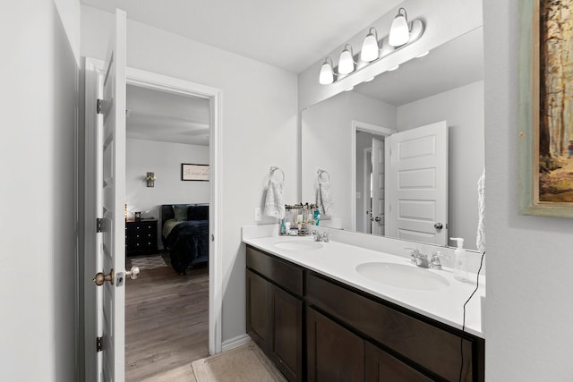 bathroom with hardwood / wood-style floors and vanity