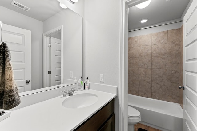 full bathroom with tiled shower / bath combo, toilet, and vanity