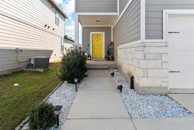 property entrance with a lawn and central AC