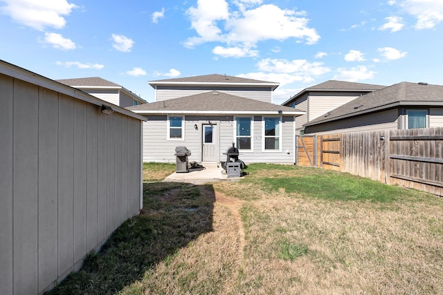 back of property featuring a lawn and a patio