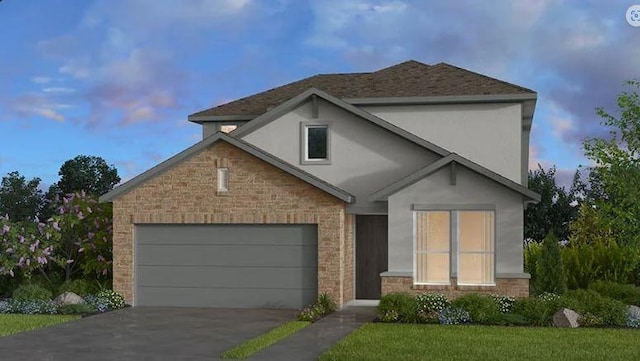 view of front of house featuring a yard and a garage