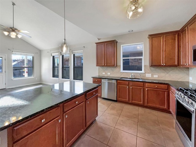 kitchen featuring sink, vaulted ceiling, decorative backsplash, appliances with stainless steel finishes, and light tile patterned flooring