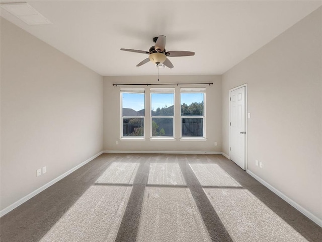 carpeted empty room featuring ceiling fan