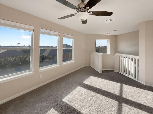 unfurnished room featuring dark carpet and ceiling fan