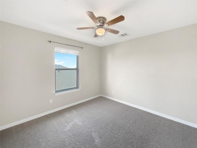 carpeted spare room featuring ceiling fan