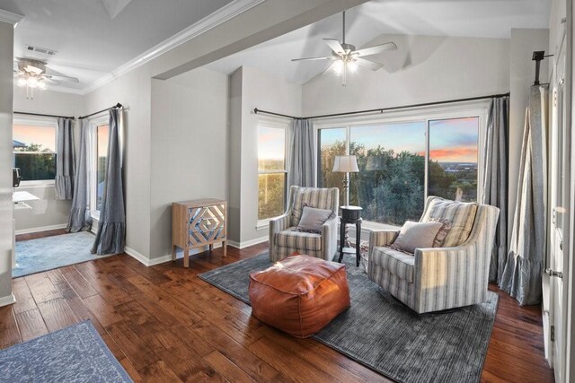 sitting room with ceiling fan, dark hardwood / wood-style flooring, lofted ceiling, and crown molding