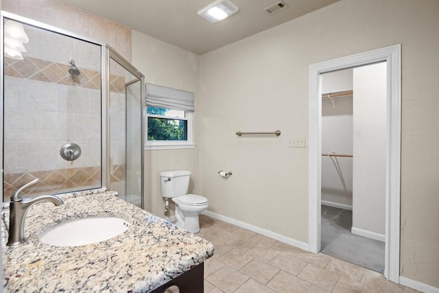 full bathroom featuring visible vents, toilet, a spacious closet, vanity, and a shower stall