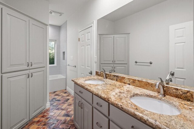 bathroom with a tub to relax in and vanity